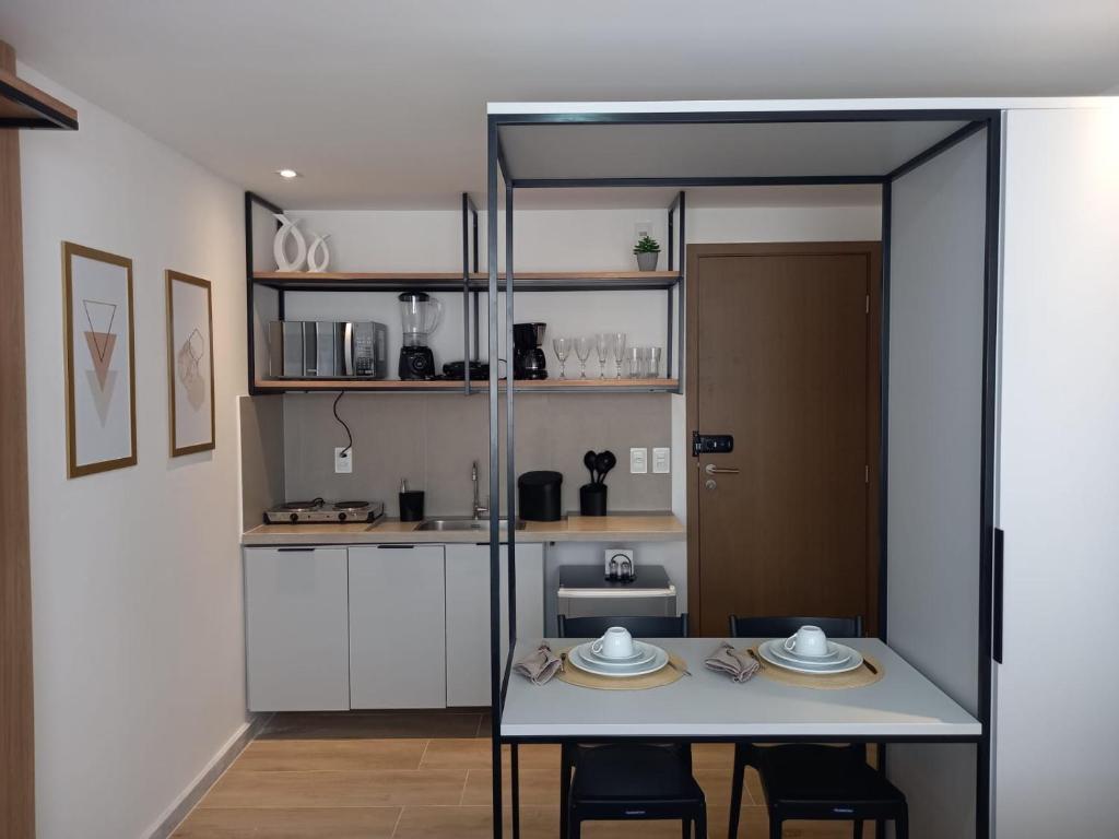 a kitchen with a table and chairs in a room at Bauten Cabo branco -Flat moderno e confortável 314 in João Pessoa