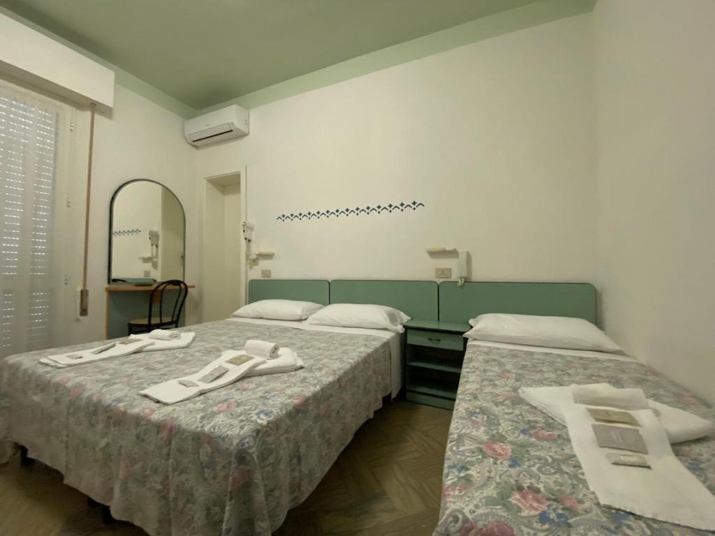 Posteľ alebo postele v izbe v ubytovaní Hotel Nanni Garnì
