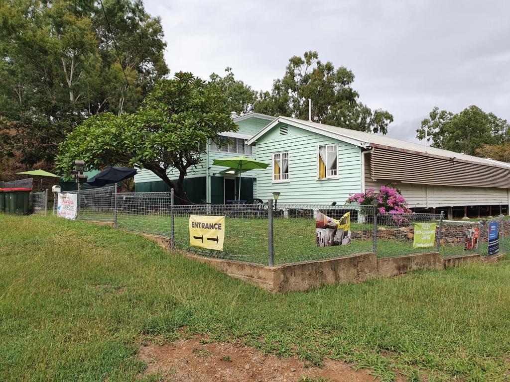 a fence in front of a house with signs on it at Meyenburg Units in Mount Morgan