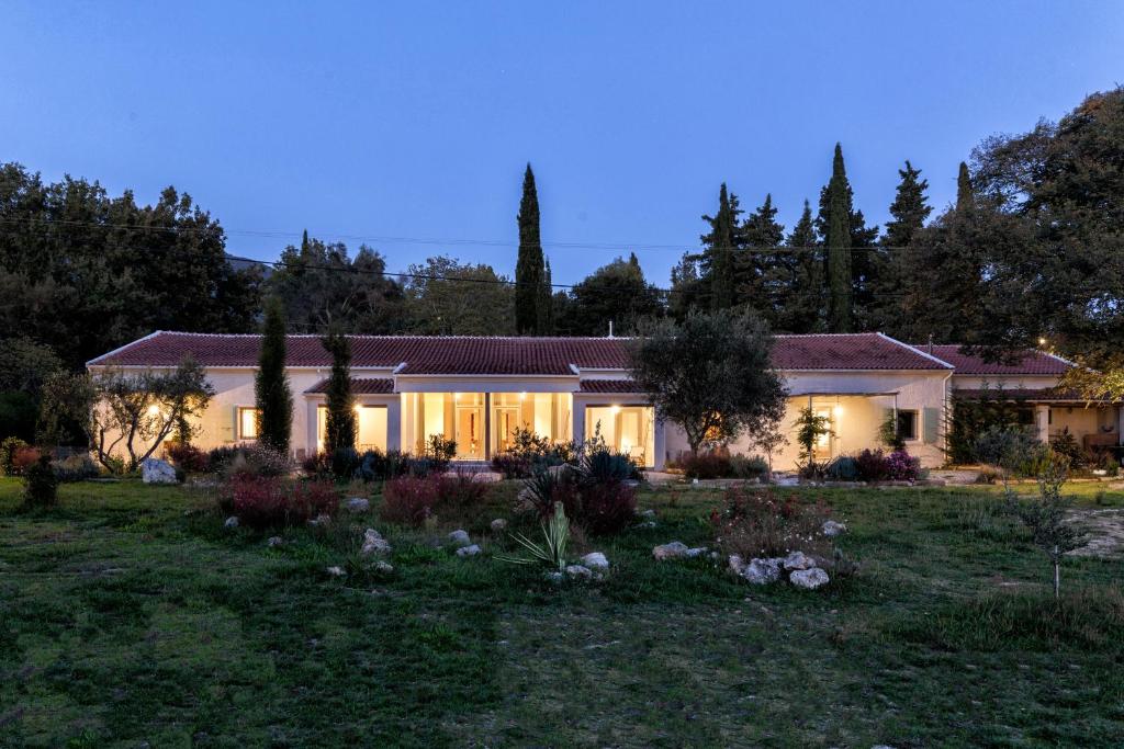 een huis met lichten aan in een tuin bij Luna Inn B&B in Corfu-stad