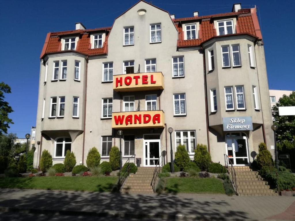 a hotel with a hotel sign in front of it at Hotel Wanda in Kętrzyn