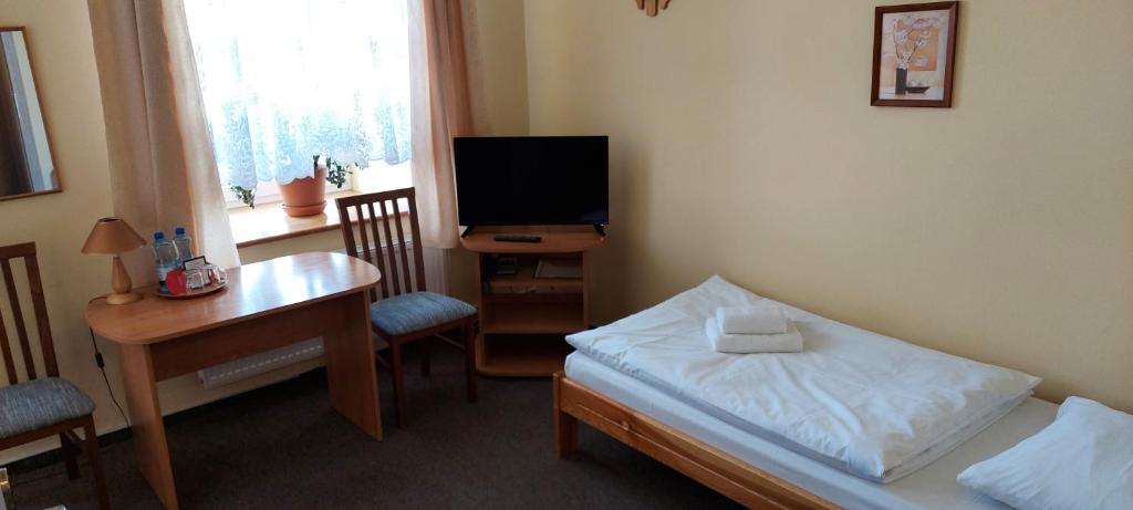 Televízia a/alebo spoločenská miestnosť v ubytovaní Hotel Wanda