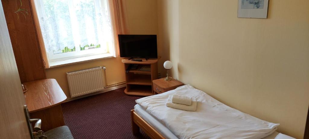 Televízia a/alebo spoločenská miestnosť v ubytovaní Hotel Wanda