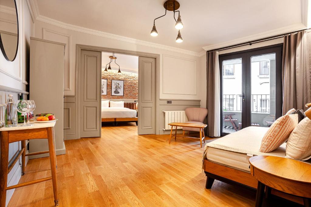 a living room with a bed and a table at World House Boutique Hotel Galata in Istanbul