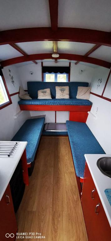 a small room with two bunk beds in a tiny house at Gypsy hut in Newtonmore