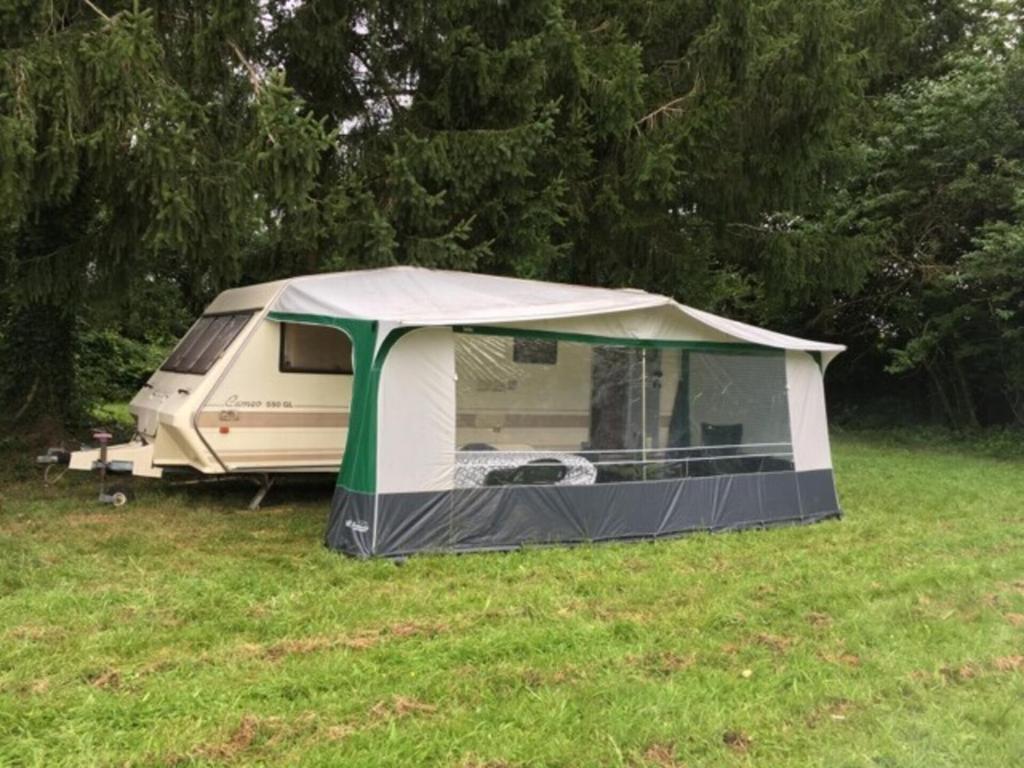 a tent sitting in the grass in a field at Inviting 2-Bed Cabin in DOMFRONT EN POIRAIE in Perrou