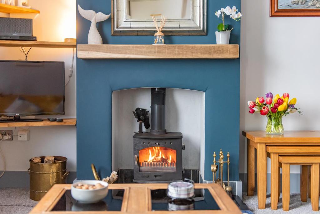 a fireplace in a living room with a stove at Castle View - Charming cottage with views of Dover Castle in Kent