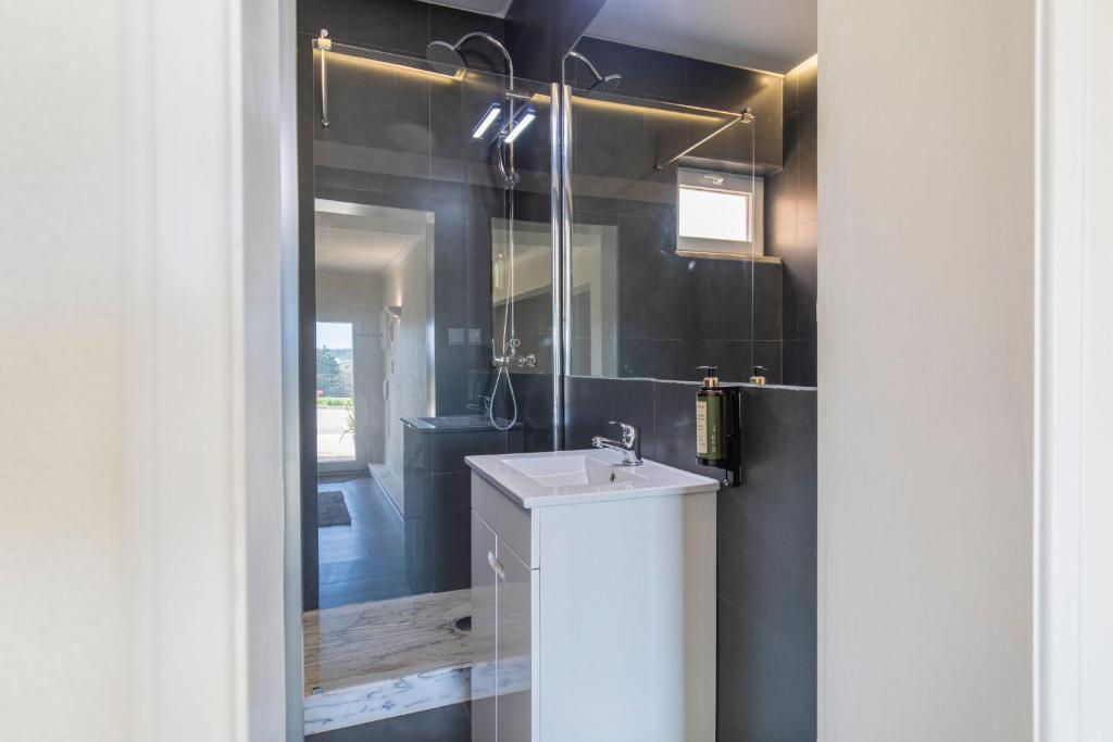 a bathroom with a sink and a mirror at Kochab Sintra by LovelyStay in Sintra