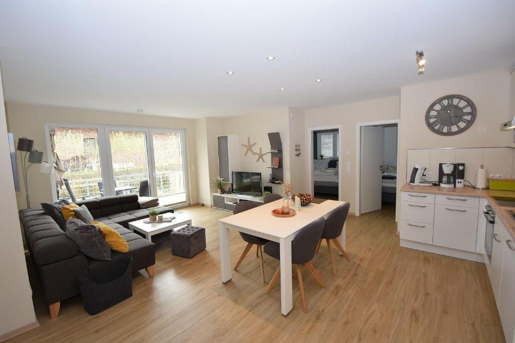 a kitchen and a living room with a table and a living room at Auszeit-Kenkel in Hohwacht
