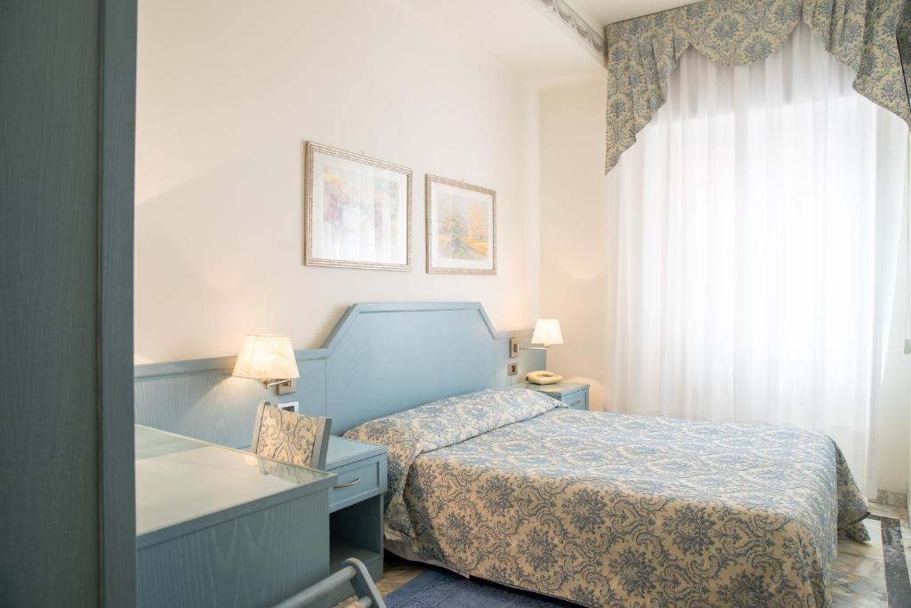 Postel nebo postele na pokoji v ubytování Hotel Ariston