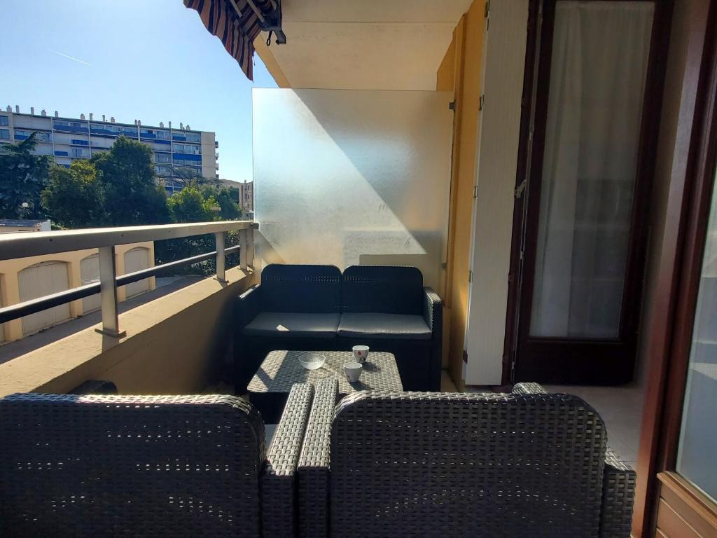 - un balcon avec deux chaises et un canapé dans un bâtiment dans l'établissement MIOUGRANO Studio 4 Personnes 29m2, à Fréjus