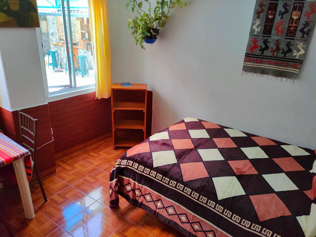 Postel nebo postele na pokoji v ubytování Hostal Chimenea