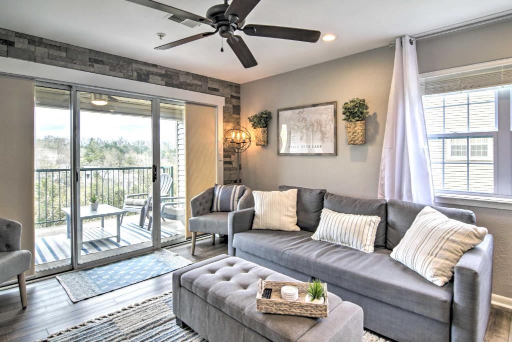 a living room with a couch and a balcony at Branson Retreat with Balcony and 18-Hole Golf Course! in Branson