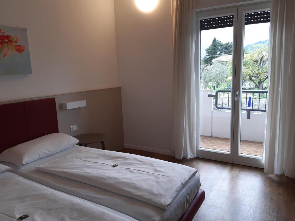 Postel nebo postele na pokoji v ubytování Hotel Villa Claudia
