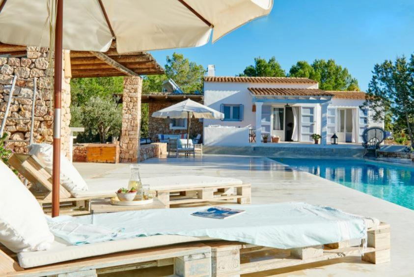 a villa with a swimming pool and a house at Ca Aquamarine -Luxurious villa, walking distance from Saona Beach in Cala Saona