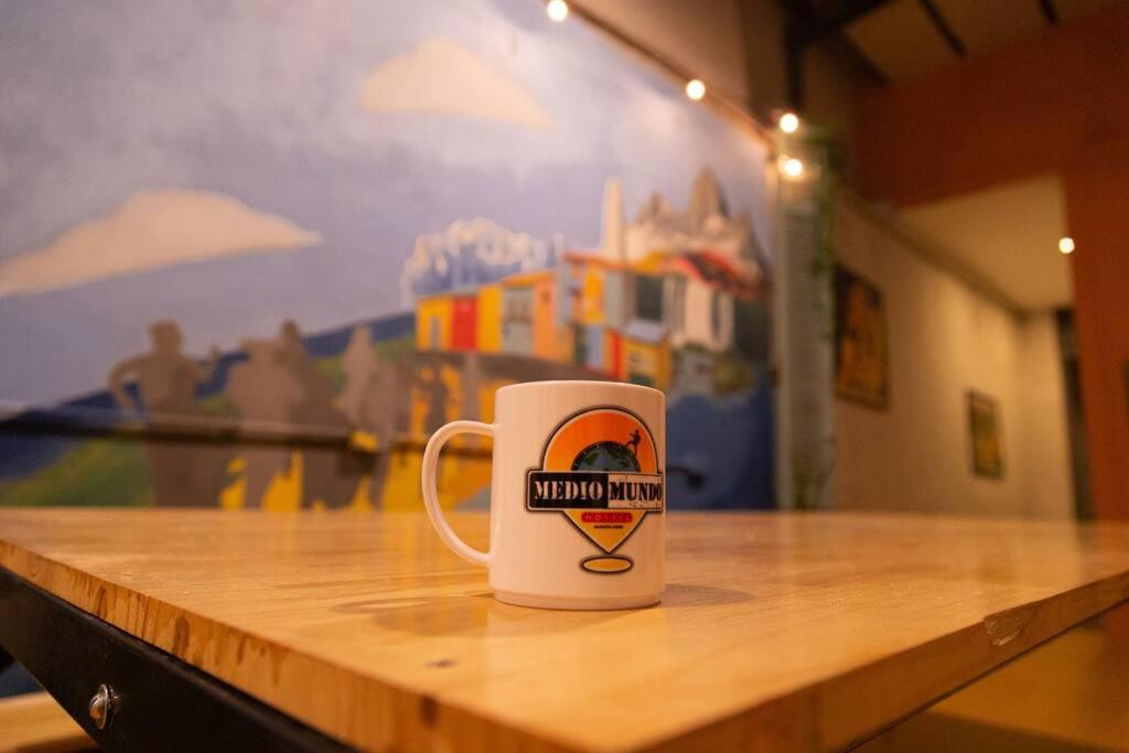 a coffee cup sitting on top of a wooden table at Medio Mundo in Buenos Aires