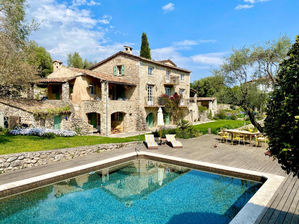 a house with a swimming pool in front of a house at L'Effrontée in Tourrettes-sur-Loup