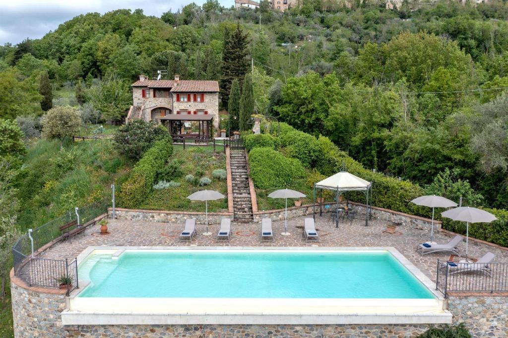 a swimming pool in front of a house at Casa Emilia in Chiusdino
