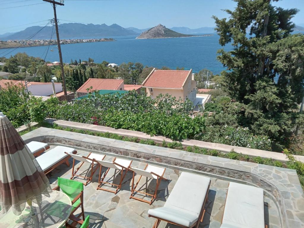 a patio with chairs and a view of the water at Fantastic House with a Wonderful View of the Sea in Kapótidhes