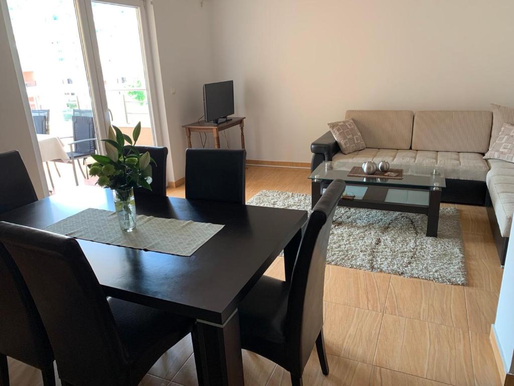a living room with a table and a couch at Apartment IDA in Budva