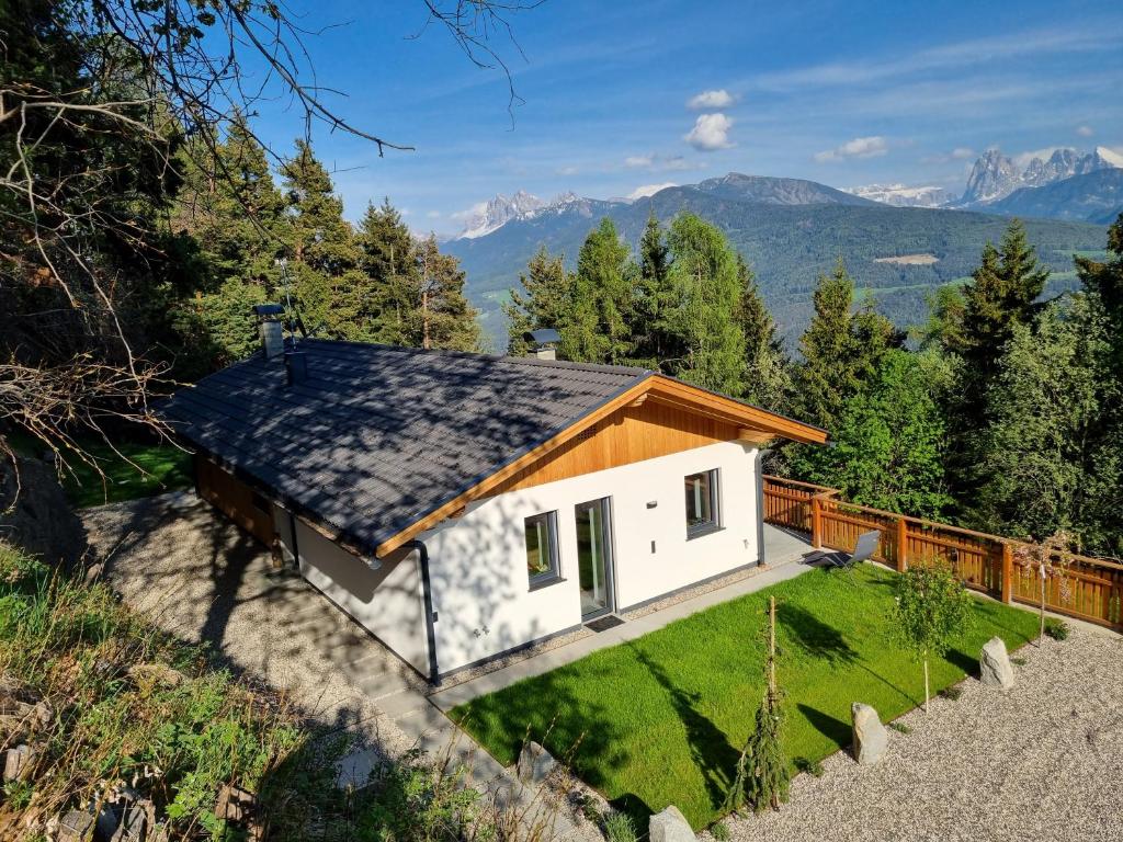 a house with a view of the mountains at Alone in Chalet with view on Dolomites in Villandro
