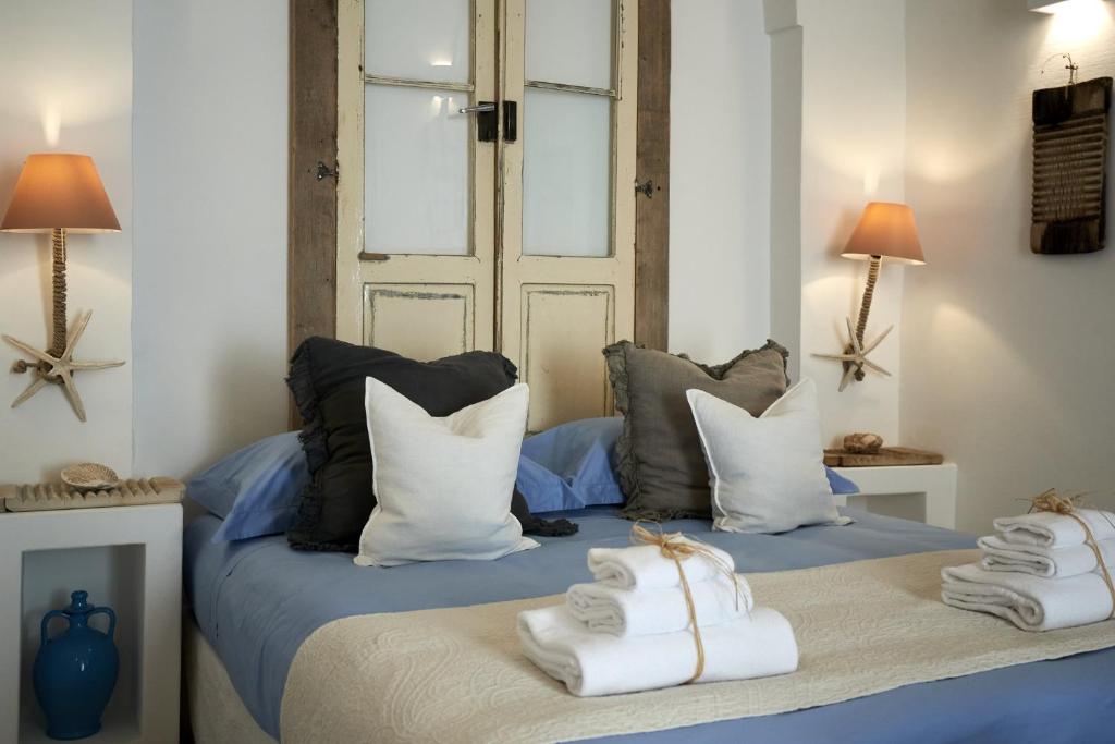 a bedroom with a bed with towels on it at Dei Serafini in Polignano a Mare