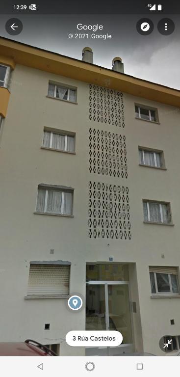 a white building with a sign on the side of it at Viveiro-Lugomar in Viveiro