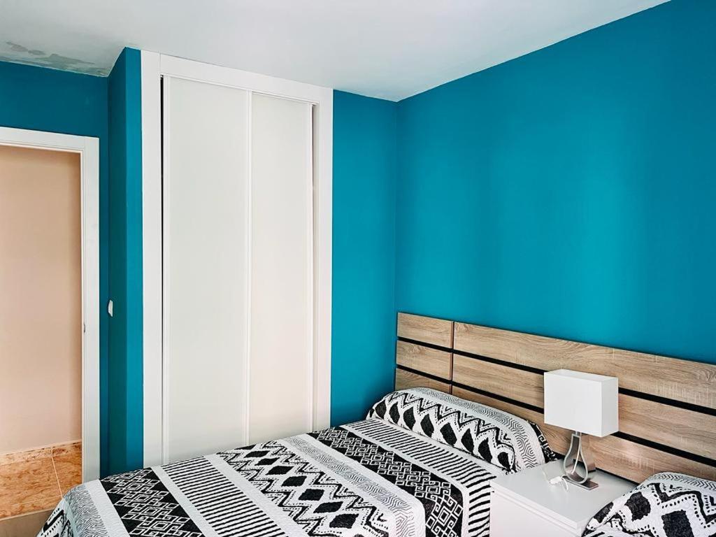 a bedroom with two beds and a blue wall at Viveiro-Lugomar in Viveiro