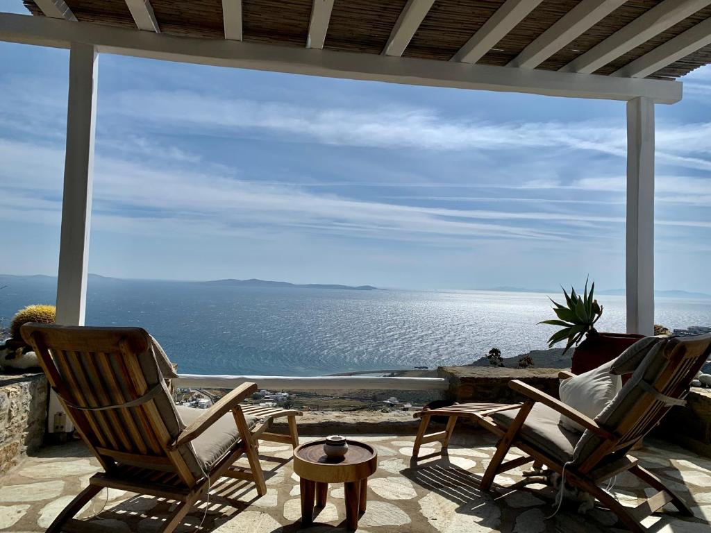 a patio with two chairs and a view of the ocean at The Seaview Lodge in Mýkonos City