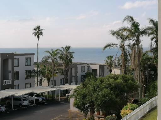 a view of a city with palm trees and buildings at Laguna la crete 169 uvongo in Margate