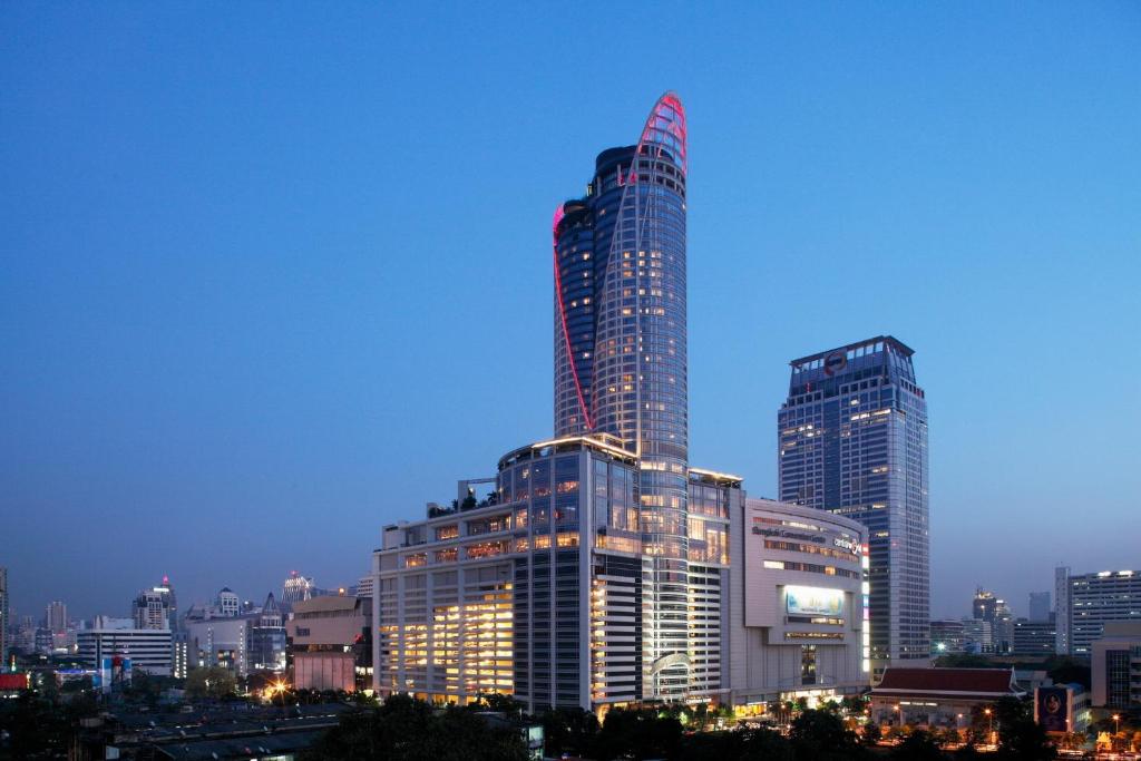 eine Skyline der Stadt mit einem hohen Gebäude in der Nacht in der Unterkunft Centara Grand At CentralWorld in Bangkok