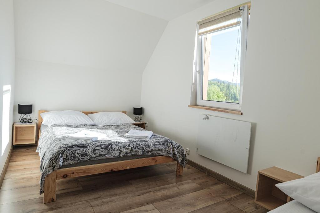 Postel nebo postele na pokoji v ubytování Domki w Górach "Osadowe Wzgórze" w Wiśle