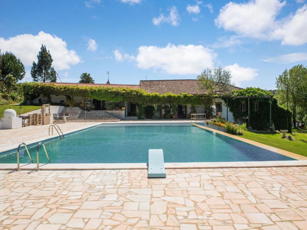 a swimming pool in front of a house at House is located on a corner in Montemor-o-Novo