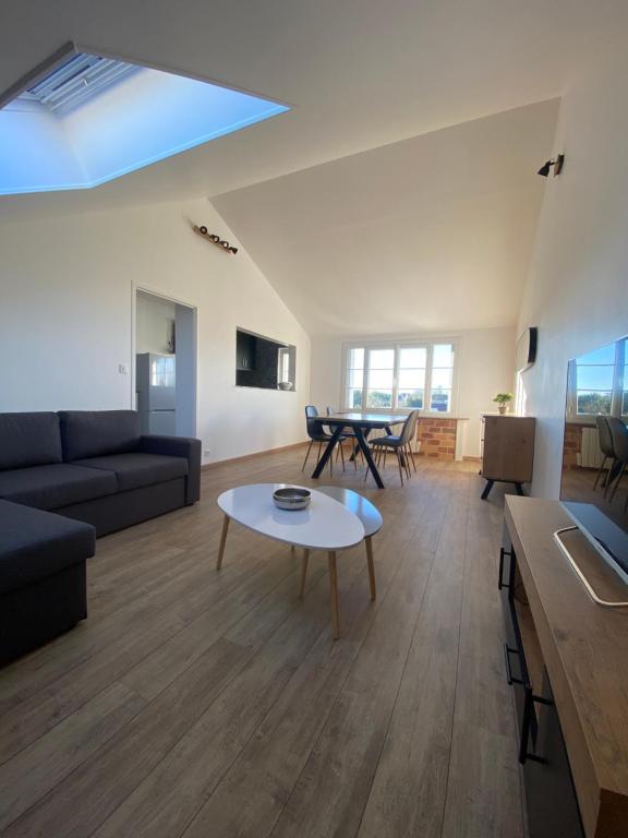 a living room with a couch and a table at Superbe appartement proche CV in Bourges