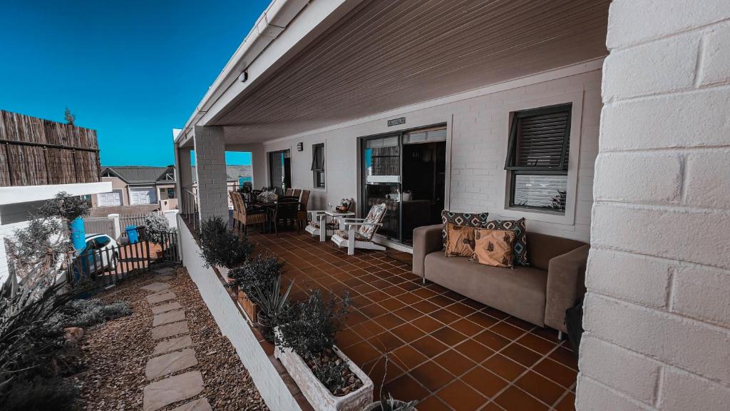 a patio with a couch on a house at Villa Paulina in Langebaan