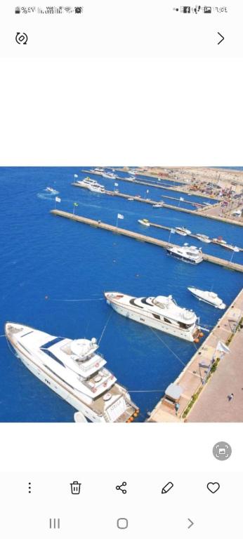two photos of boats docked in a harbor at Porto marina luxury flat for families onlyشاليه فاخرداخل بورتو مارينا in El Alamein