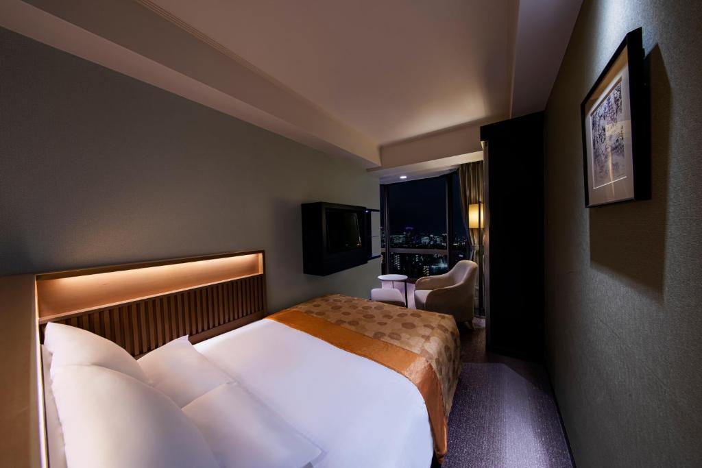 Postel nebo postele na pokoji v ubytování Asakusa View Hotel