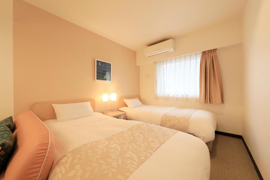 Postel nebo postele na pokoji v ubytování Hotel Famy Inn Kinshicho