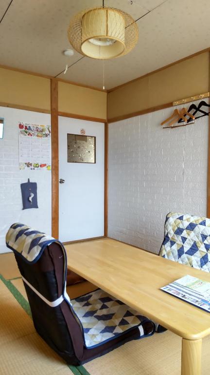 una mesa y una silla en una habitación en Guest House Yamada, en Date