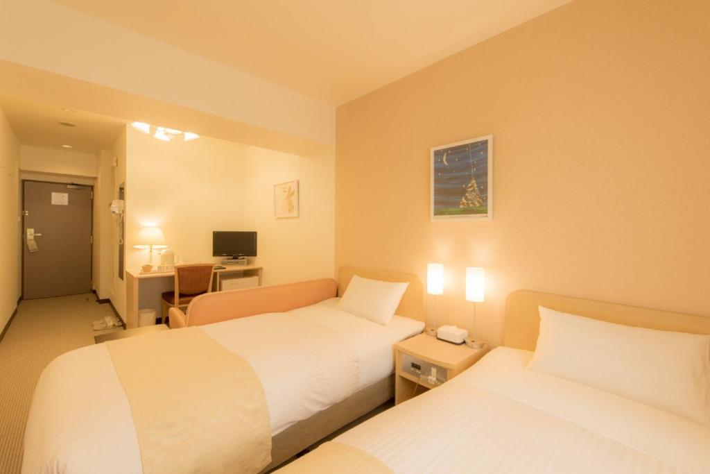 Postel nebo postele na pokoji v ubytování Hotel Famy Inn Kinshicho