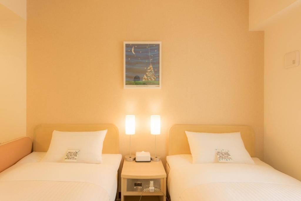 Postel nebo postele na pokoji v ubytování Hotel Famy Inn Kinshicho