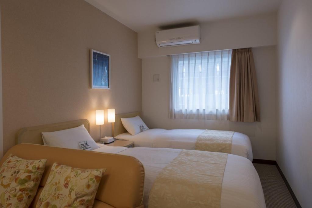 Postel nebo postele na pokoji v ubytování Hotel Famy Inn Kinshicho