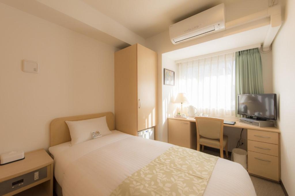 Postel nebo postele na pokoji v ubytování Hotel Famy Inn Kinshicho