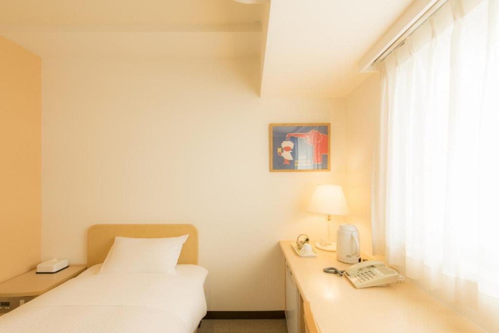 Postel nebo postele na pokoji v ubytování Hotel Famy Inn Kinshicho
