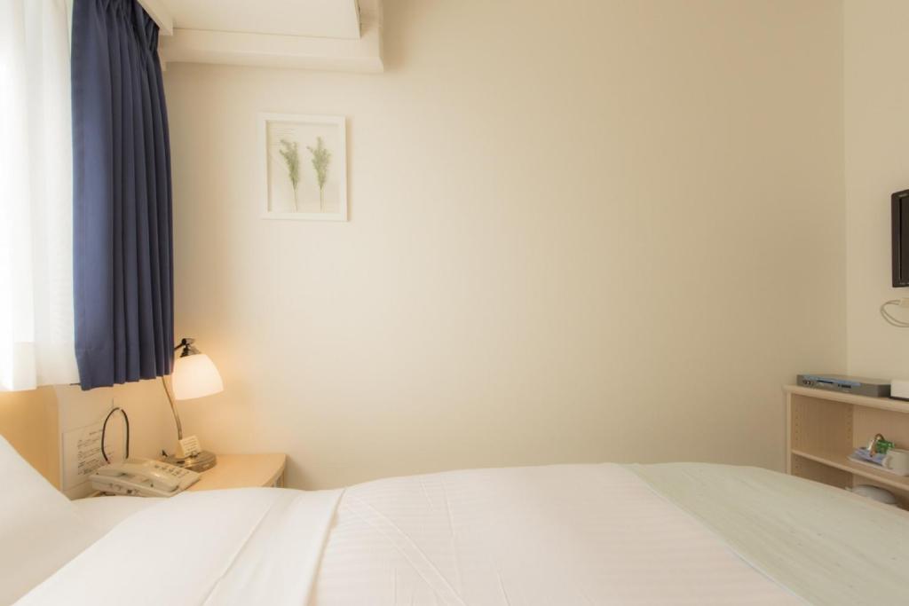 Postel nebo postele na pokoji v ubytování Hotel Famy Inn Kinshicho