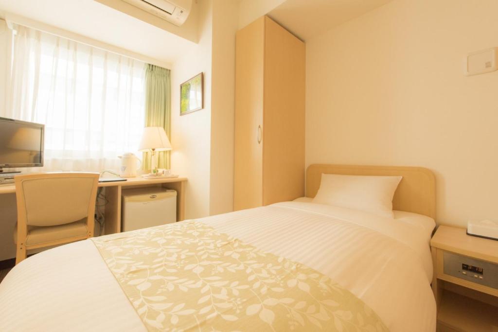 Postel nebo postele na pokoji v ubytování Hotel Famy Inn Kinshicho