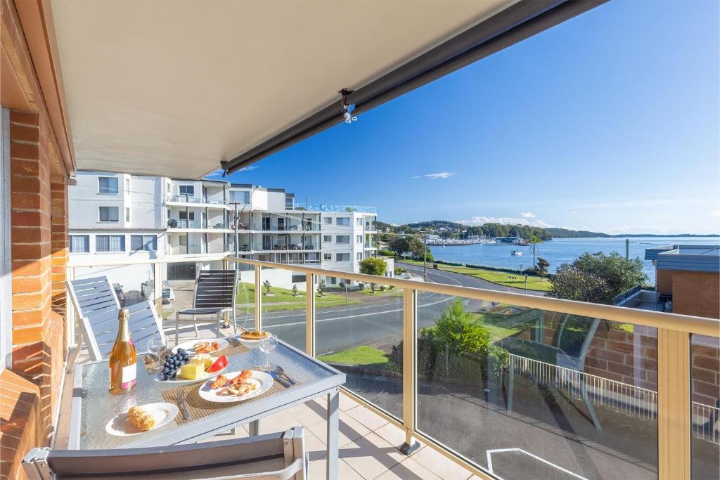 a balcony with a table and a view of the water at Blue Vista 8 13 Victoria Parade in Nelson Bay