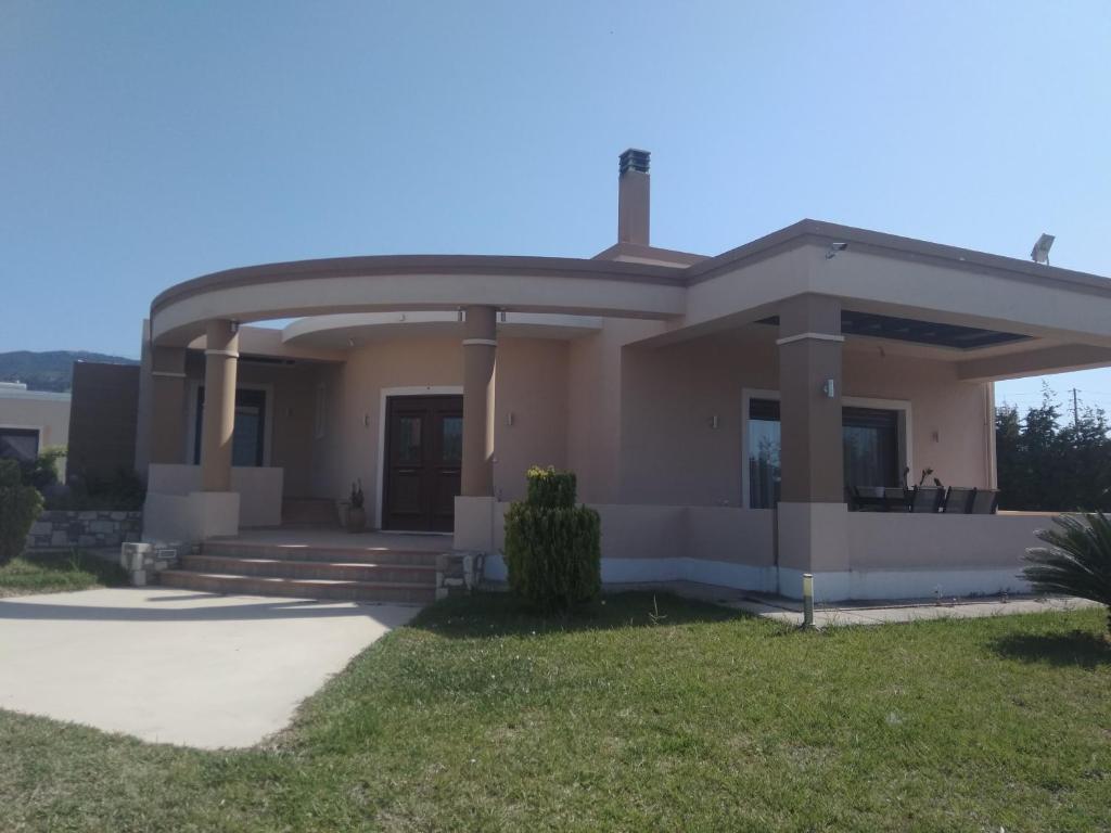 a small house with a circular roof at Kos Villa - Family Comfort with large Garden, Jacuzzi in Kos