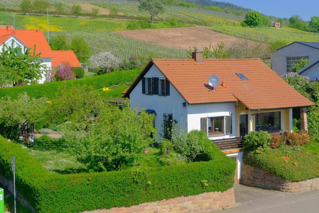 a small white house with an orange roof at Ferienweingut Wissing Wohnung Theo in Gleiszellen-Gleishorbach