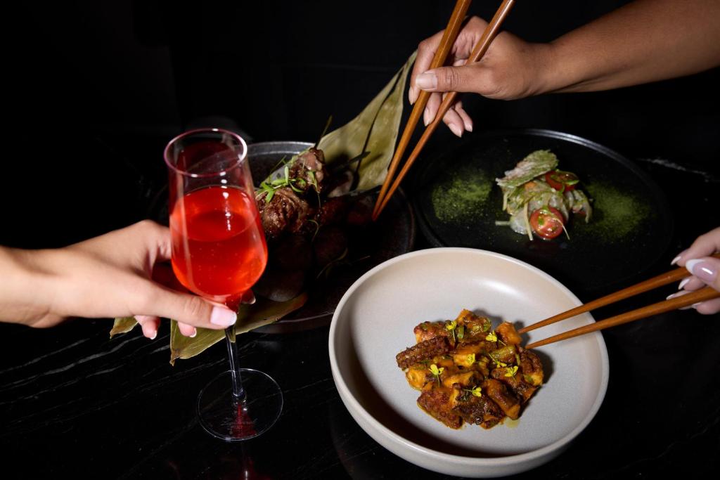 a table with a plate of food and a drink at Mövenpick Hotel Auckland in Auckland